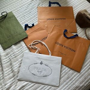 3- Louis Vuitton gift bags, 1- Prada, 1-Gucci
